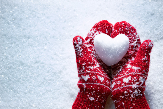 Mittens holding a snowball heart